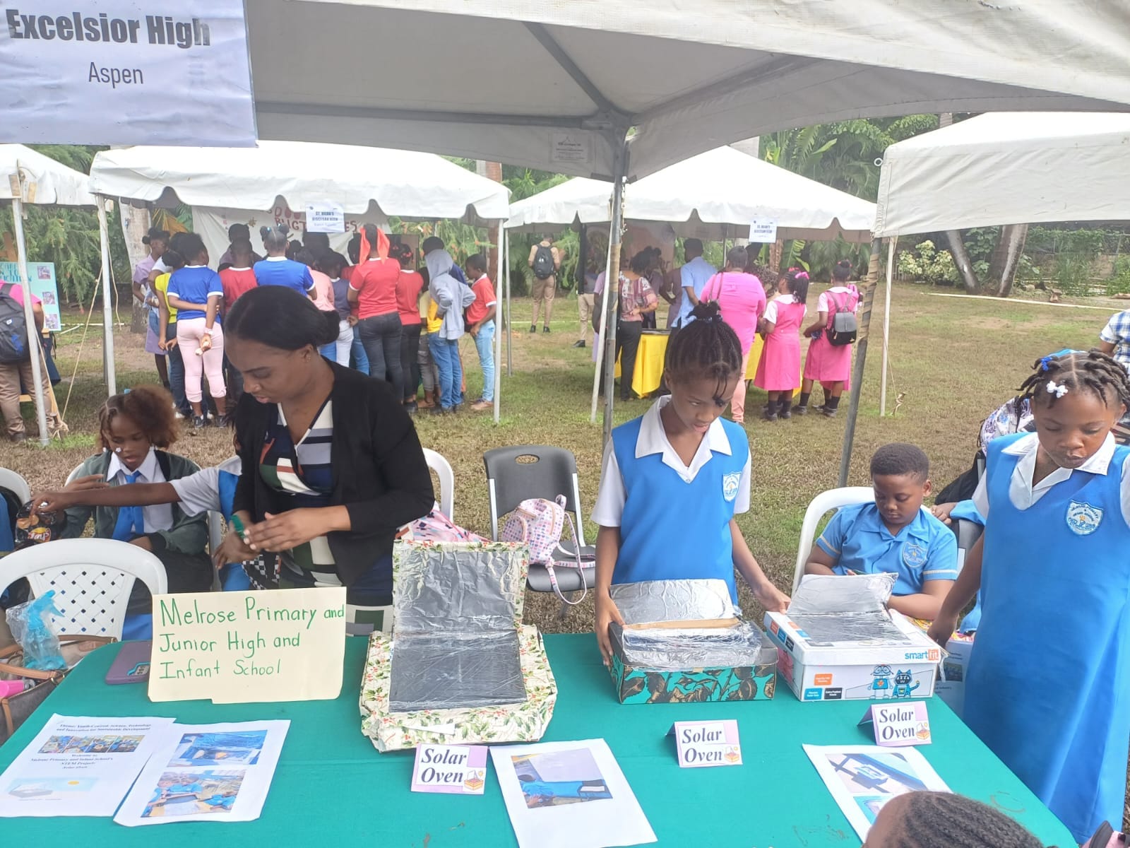 STEAM Club pupils and teacher displaying solar oven projects
